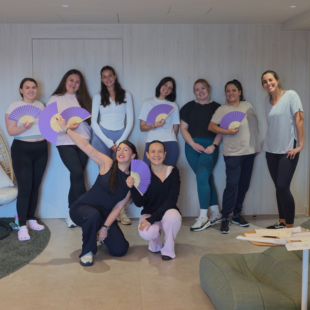 ArmoYoga participants with purple fans at City Tower, Manchester